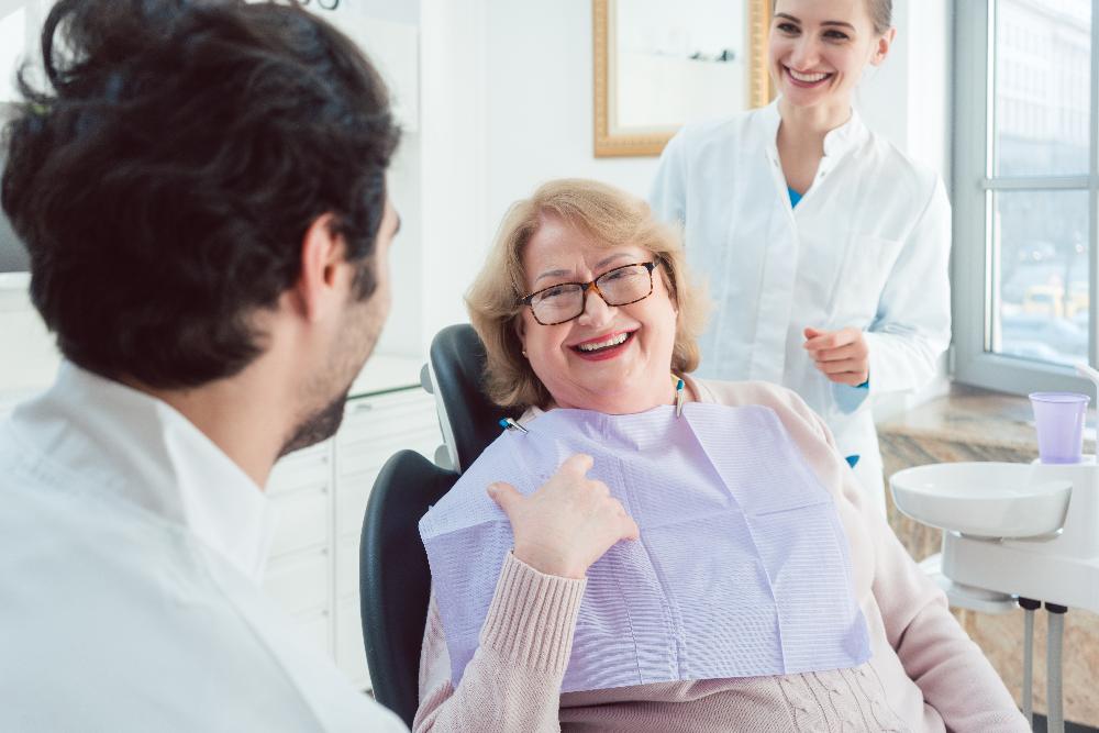 Older woman smiling in dental chair, brentwood tn