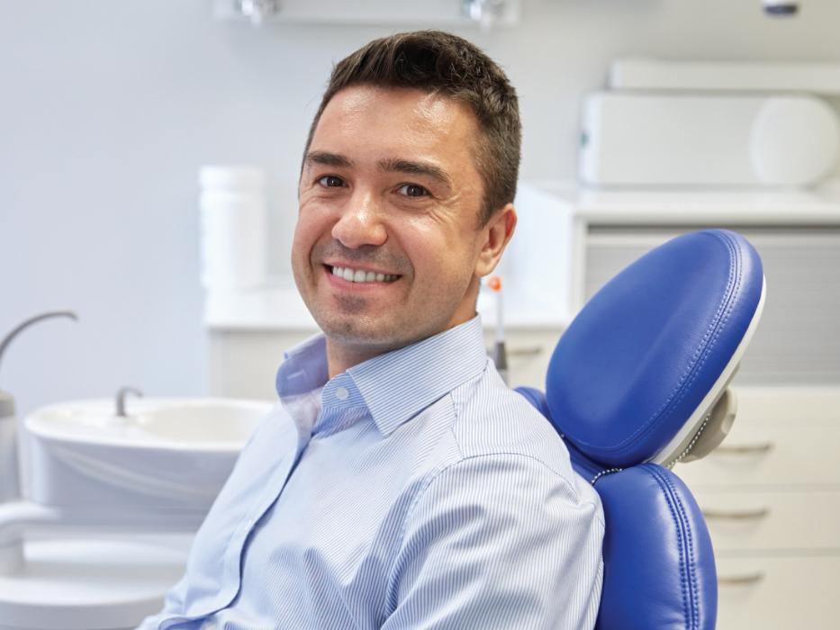 man sitting in dental chair after getting dentures | dentist nashville tn