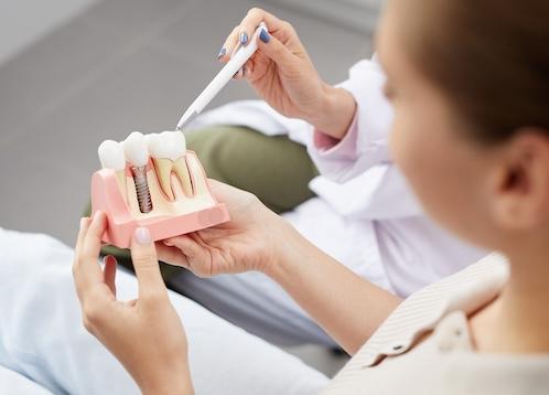 Dentist showing a patient a diagram of a dental implant, nashville tn