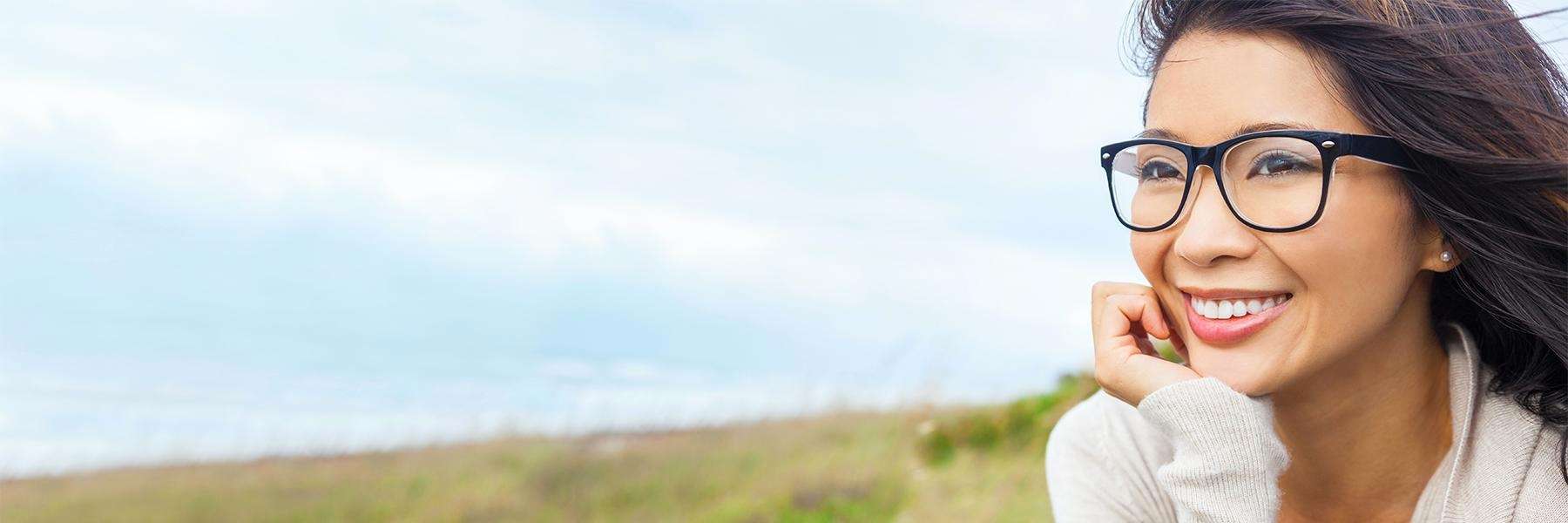 Woman smiling in a field | Dentist Brentwood, TN