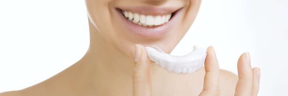 Woman smiling with invisalign tray, brentwood tn