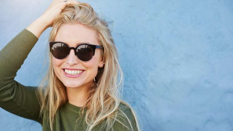 A woman smiling in sunglasses | teeth whitening Brentwood TN
