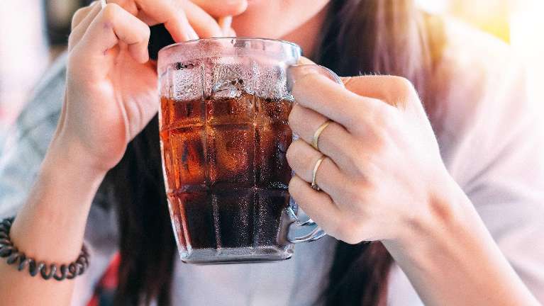 A woman drinking a Coke