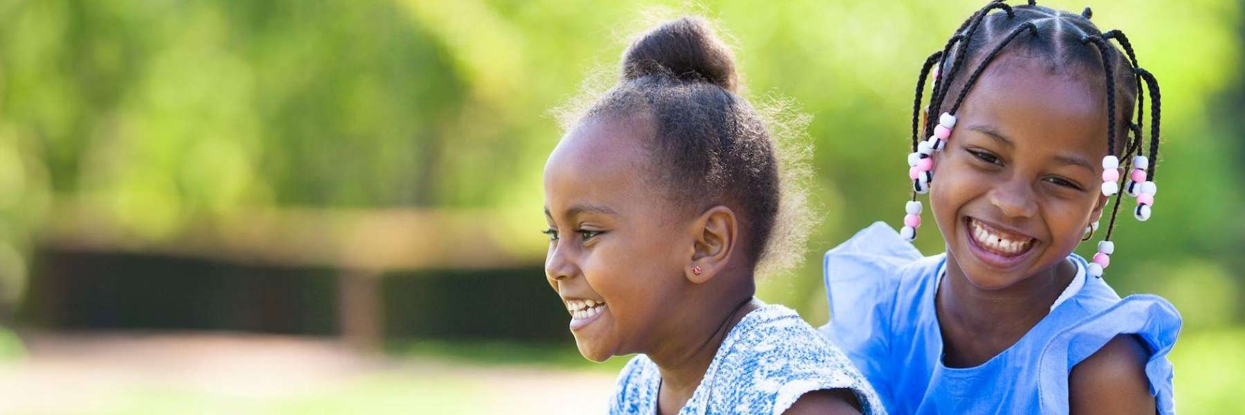 Two young black girls smiling at each other, brentwood tn
