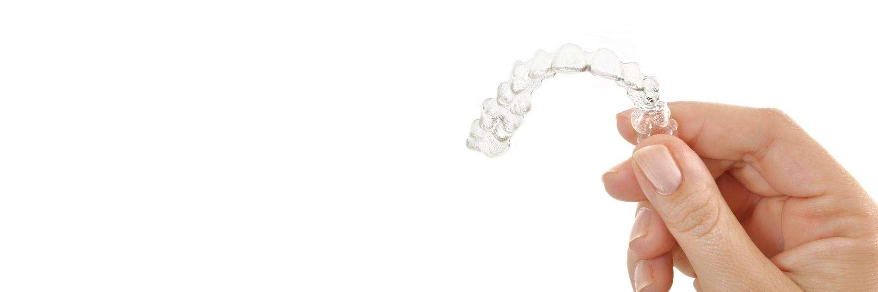 person holding clear braces in brentwood tn
